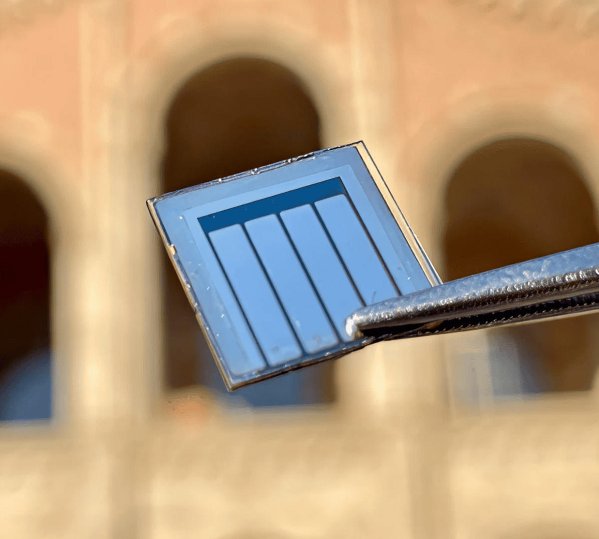 Tweezers gripping small electronic chip