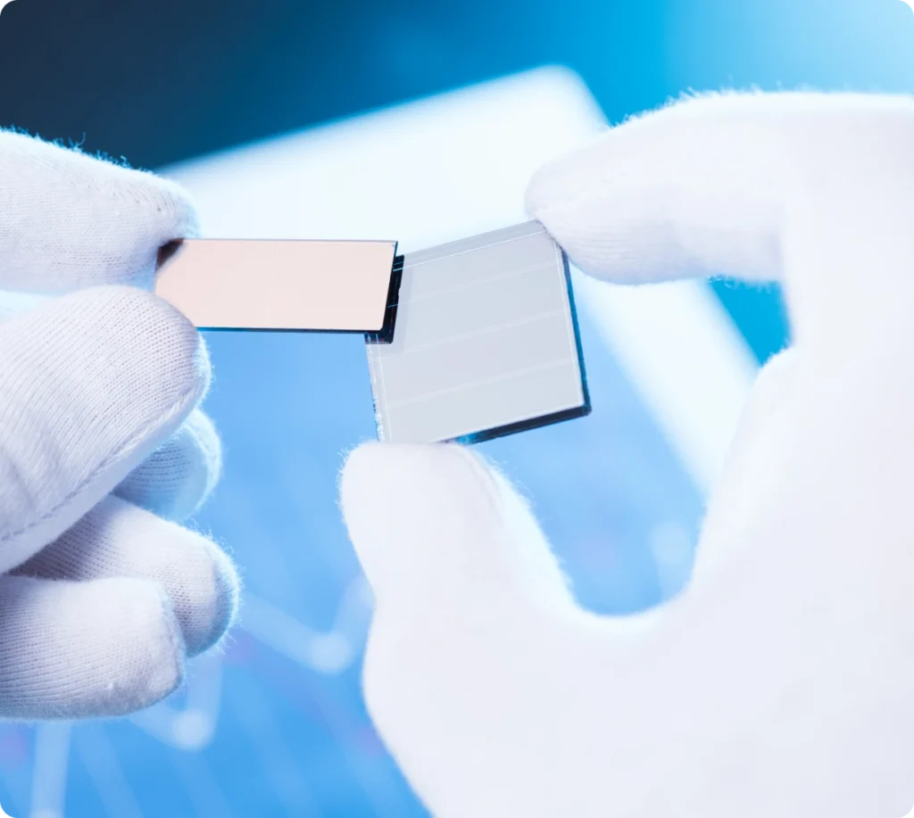 Gloved hands holding small electronic component
