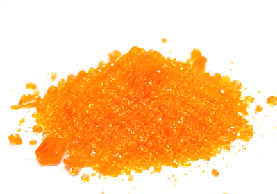 Orange crystal powder on white background