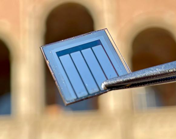 Small rectangular solar cell held by tweezers